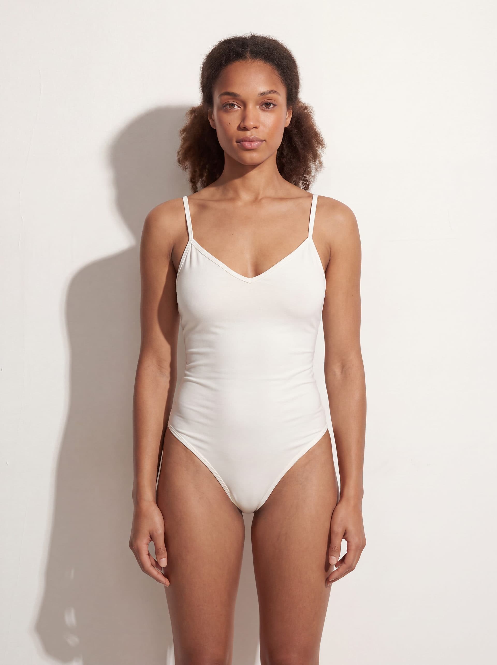 Body para dama con tirantes cuello V, en color blanco, puesto en modelo