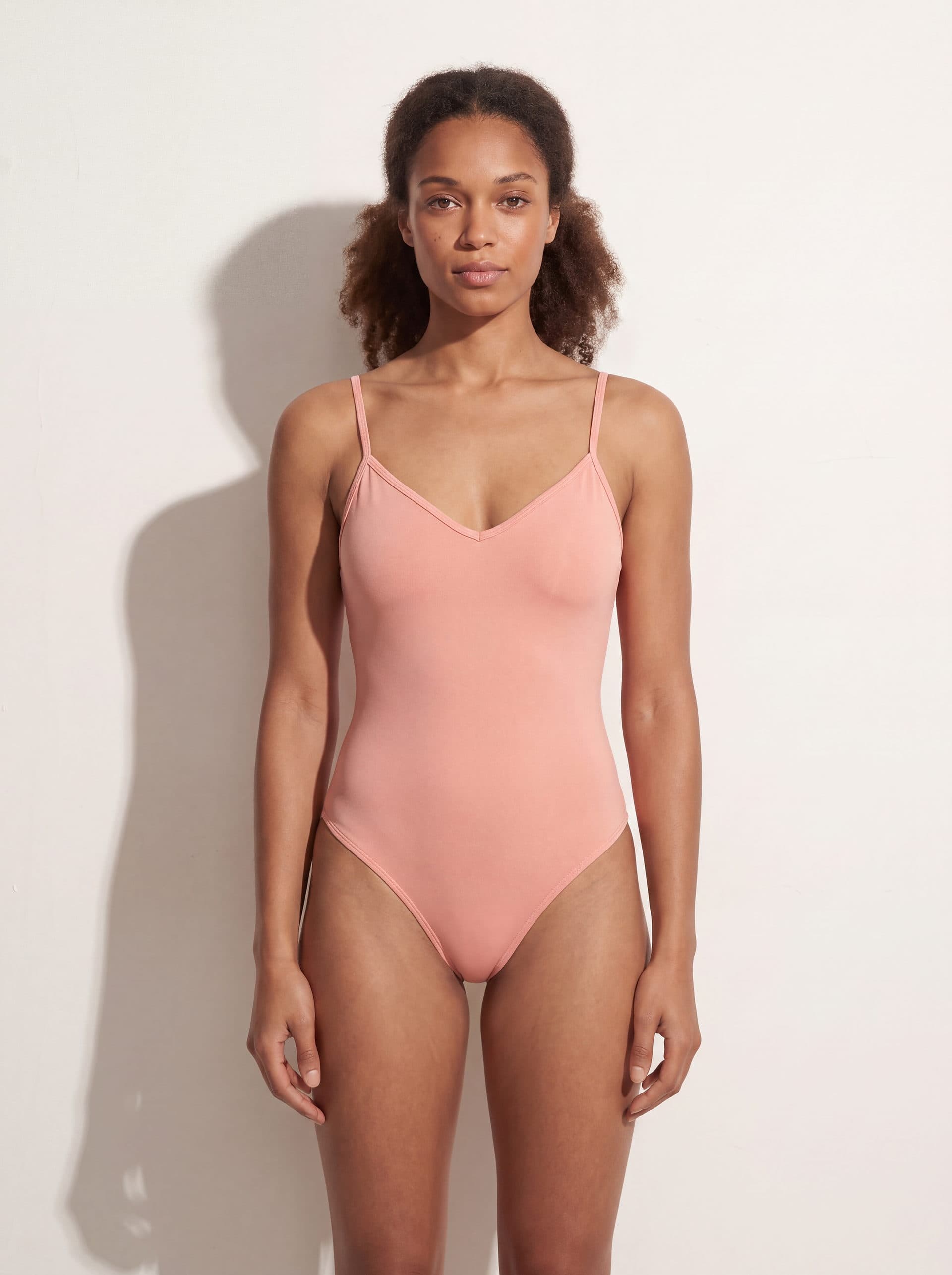 Body para dama con tirantes cuello V, en color rosado, puesto en modelo