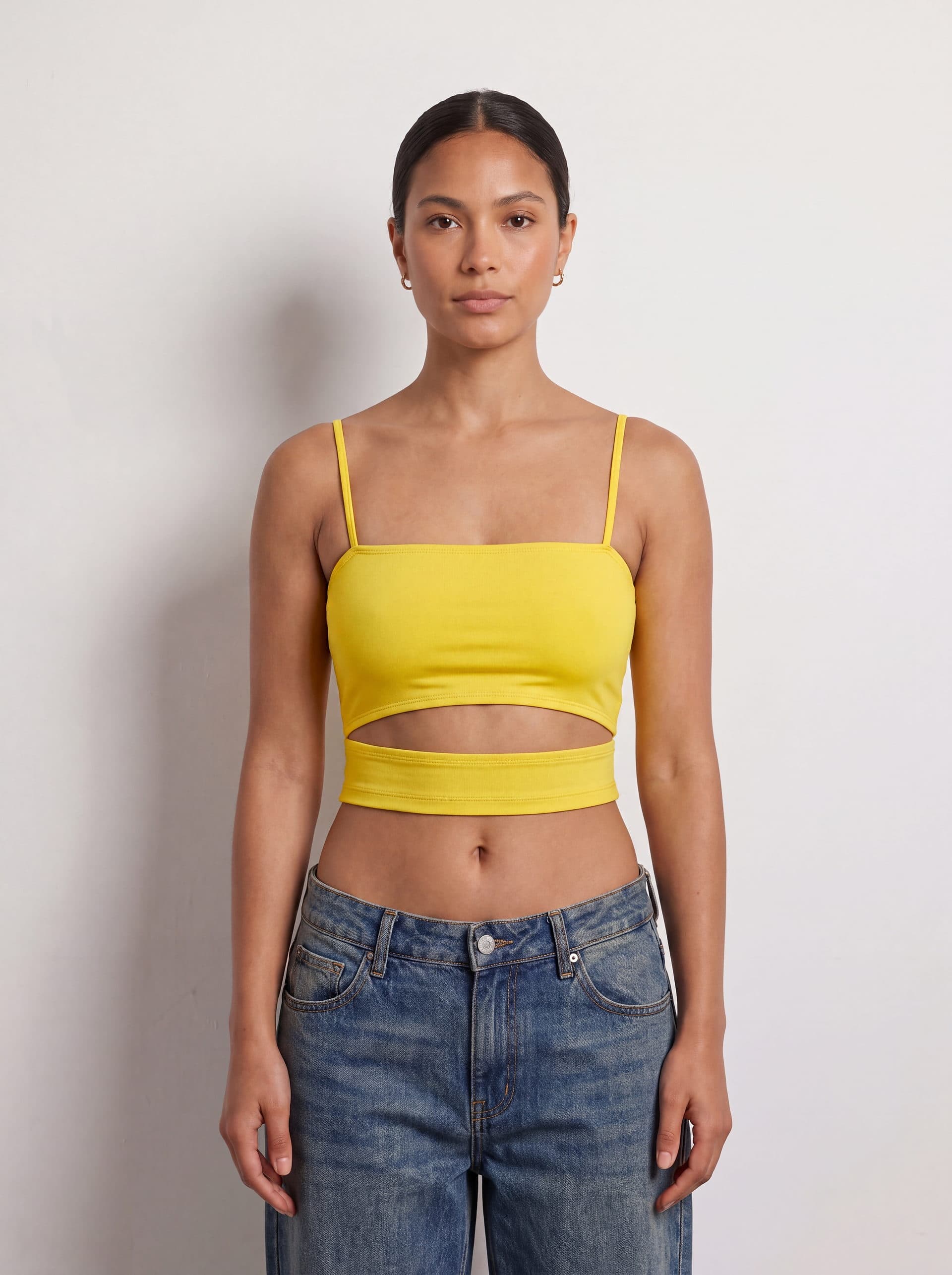 Crop top con abertura en cintura, en color amarillo, puesto en modelo